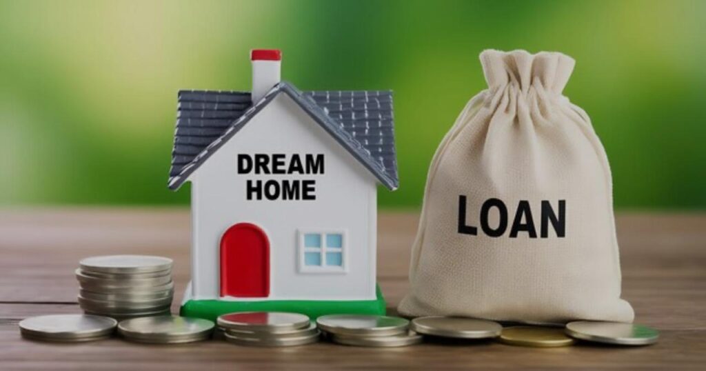 Miniature house labeed "Dream Home" beside a money bag labeled "Loan", surrounded by stacked coins, symbolizing home loan financing